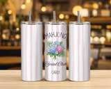  skinny tumbler with pink and white vertical stripes are lined up on a wooden table. The center image features a custom graphic with the text 'MAHJONG Social Club' and the name 'CARLY' alongside a bouquet illustration.
