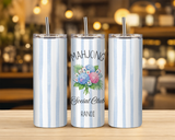 insulated tumblers with clear lids and metal straws sit on a wooden table in a blurred bar or cafe setting. The left and right images have light blue and white vertical stripes, while the center image has a floral graphic with playing cards and the text 'MAHJONG Social Club RANDI'.