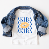 A white graphic T-shirt styled with an open blue denim jacket on a light background. The shirt features a graphic print with the word 'AKIBA' repeated in blue and a large yellow-orange lipstick kiss mark in the center.
