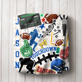 a throw blanket printed with a colorful football-themed 'TOUCHDOWN' design, folded up.