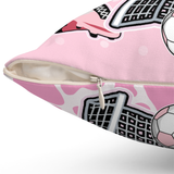 A close-up of a pink zippered throw pillow showing that the pillow insert is inside a removable pillow cover. 