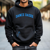 A man wearing a black hoodie with 'DANCE DADZZ' printed in blue across the chest and a blue signature graphic on the pocket, standing outdoors with his hands in his pockets.