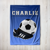 Ombre blue throw blanket with the name 'CHARLIE' in white varsity font at the top. A big image of a soccer ball and cleat taking up most of the blanket. 