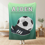 Ombre green throw blanket with the name 'AIDEN' in white varsity font at the top. A big image of a soccer ball and cleat taking up most of the blanket. 