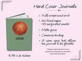 A custom hardcover journal shown on a light pink background with product details. The journal has a sage green cover with an orange basketball graphic and the name 'LUCAS' printed on the front.