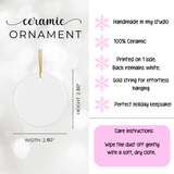 A white ceramic Christmas ornament with a gold hanging string, shown on a light background with printed dimensions (width and height 2.80 inches) and care instructions.