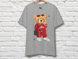 Grey t-shirt featuring a cartoon teddy bear wearing sunglasses and a red tracksuit with the text "Camp Pontiac" on it's shirt, and the camp's zip code down the pants leg. The bear is holding a pink soft drink and a black hand bag, and wearing white sneakers.