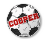 Soccer ball pillow with the name 'COOPER' printed across it in red. 