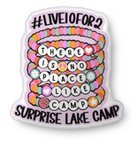 stack of camp bracelets shaped throw pillow, with #live10for2 at the top, surprise lake camp at the bottom, and within the beads in the bracelets it says 'there is no place like camp'.