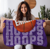 purple throw blanket with 'HOOPS' going down the whole blanket on repeat. a big basketball in the center with a name in white going through it. 