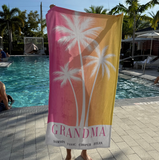 A pink and yellow ombre towel that has 'GRANDMA' with the 4 grandkids names at the bottom. 