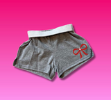Grey shorts with red bow. 