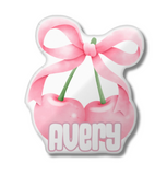 Pink cherry and bow shaped pillow with the name 'AVERY' at the bottom. 