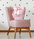 Pink cherry and bow shaped pillow with the name 'AVERY' at the bottom. 