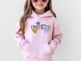 Light pink hoodie with ransom style decorative text spelling out a camp name, with a leopard print star, blue bow and glittery gold heart. 
