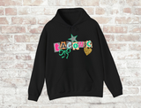 Black hoodie with ransom style decorative text spelling out a camp name, with a leopard print star, green bow and glittery gold heart. 
