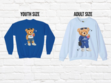 Two sweatshirts shown side by side on a white brick background, labeled YOUTH SIZE and ADULT SIZE. The left sweatshirt is royal blue and the right is light blue.