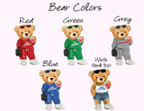 A color-options graphic showing five teddy bears wearing different colored sweatsuits labeled Red, Green, Grey, Blue, and White (tank top) under the heading 'Bear Colors' on a pale pink background.