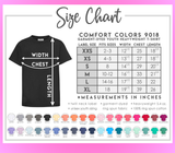 A size chart graphic for Comfort Colors 9018 youth t-shirts, showing a black t-shirt with width and length measurement arrows, a size table from XXS to XL, fabric details, and a row of color swatches on a pink background.
