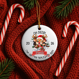 A round white Christmas ornament with a gold hanging string, featuring a cartoon reindeer wearing a Santa hat and the text 'OH DEER! I'm on the NAUGHTY LIST!' with dates 20 and 26. The ornament is styled on a red knit sweater with candy canes and pine branches.