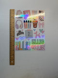 A sheet of personalized planner stickers with holographic accents and the name 'ELLIE' repeated, shown next to a wooden ruler on a white textured background.